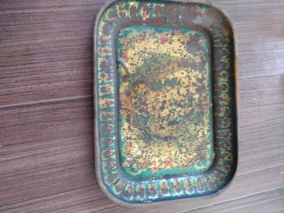 This Chinese Qing Dynasty tin plate is nearly 200 years old and has rust and dents.
