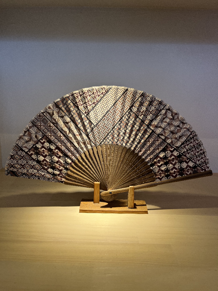 wooden fan painted on a wooden stick used as a vessel for admiring cherry blossoms