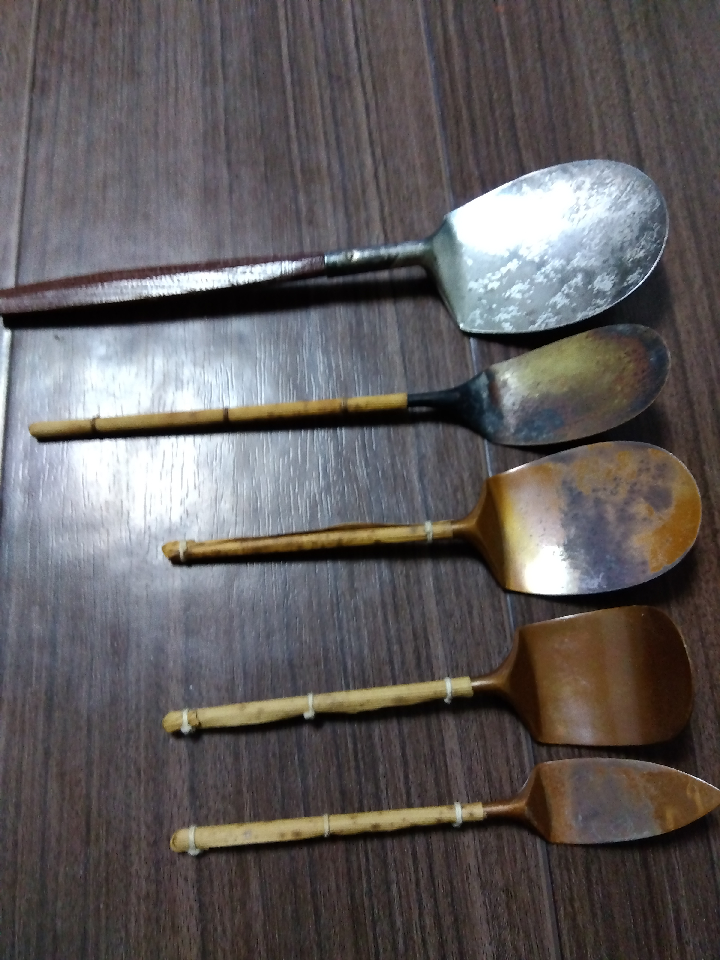 Set of 5 ash spoons. Tea utensils. The top one is finished in silver. All others are brass. They are old and have signs of use.